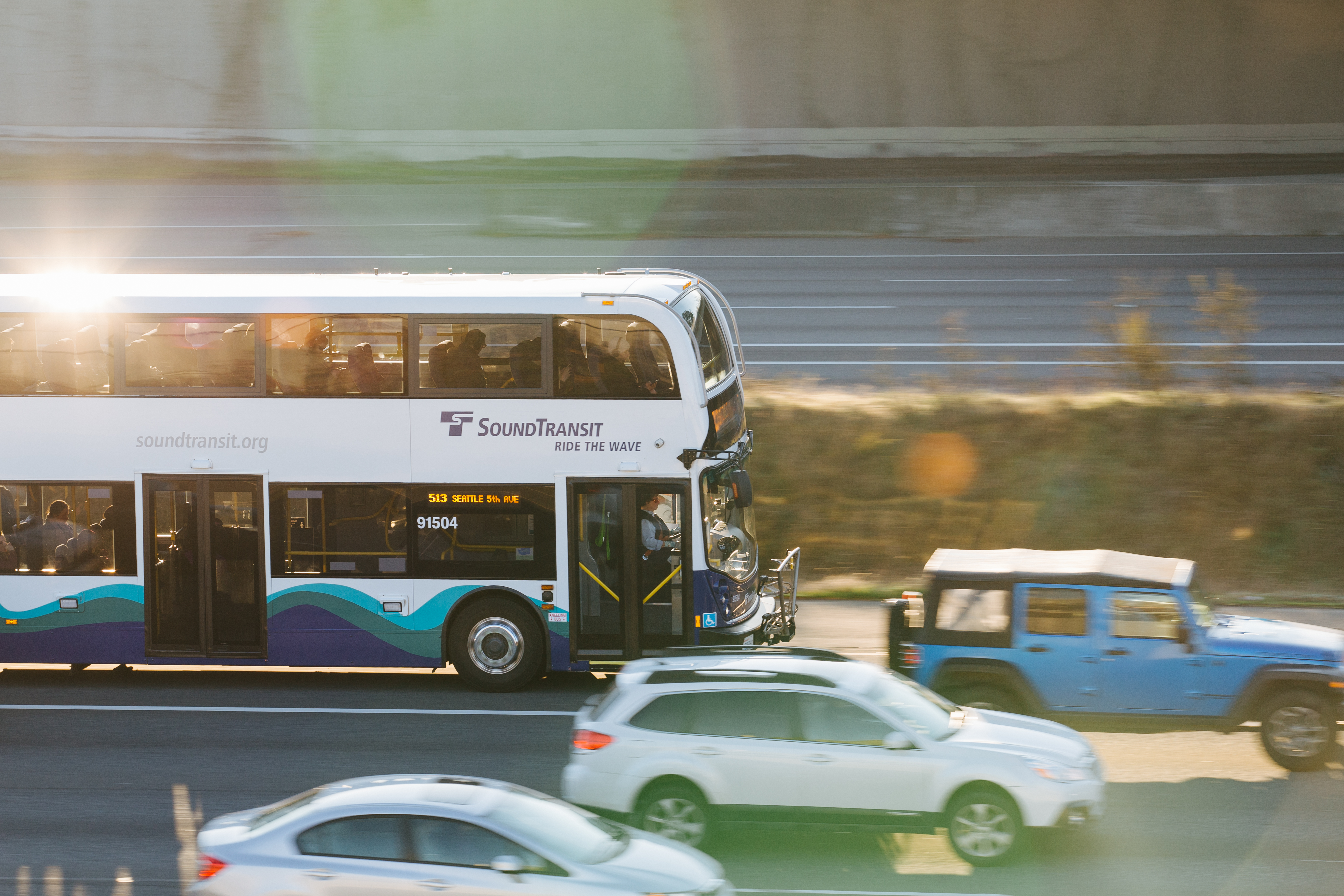 Photo of an Express bus route 513 driving in the fast lane along a highway.